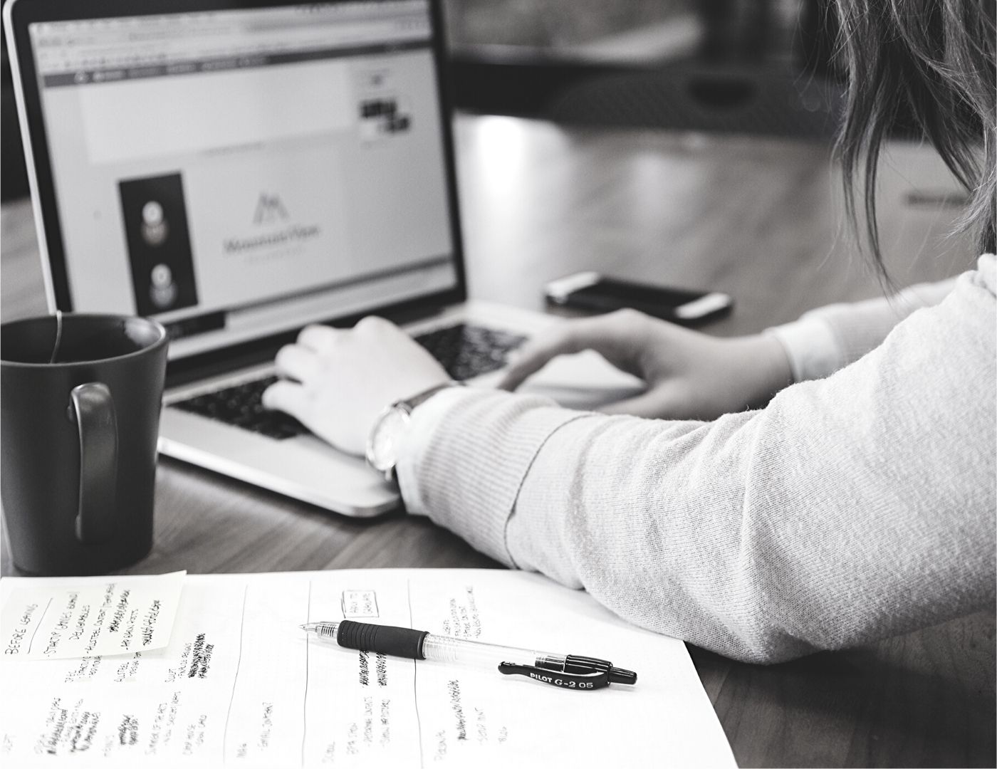 Woman Using Laptop On Table